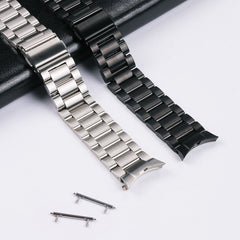Close-up of push button clasp on stainless steel strap