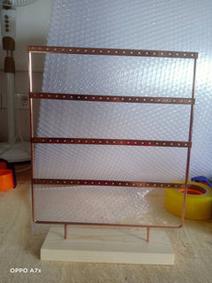 Close-up of Metal Earring Holder with Wooden Base - Image 2