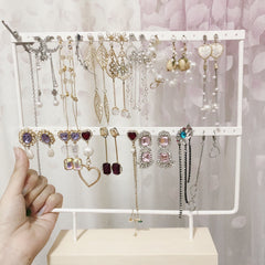 Close-up of Metal Earring Holder with Wooden Base - Image 2