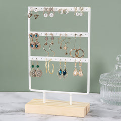 Close-up of Metal Earring Holder with Wooden Base - Image 2