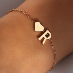 Fashionable gold letter bracelet on model