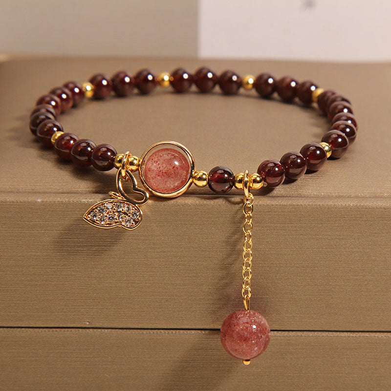Garnet crystal bracelet with multiple charms