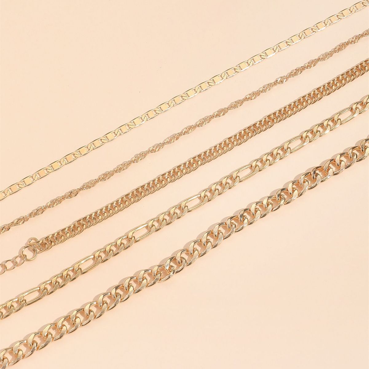 Stacked view of multiple snake chain anklets