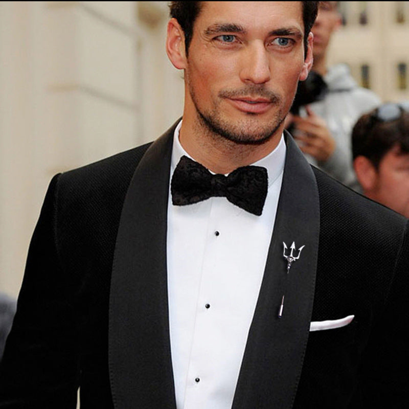 Stylish trident lapel pin displayed on a shirt