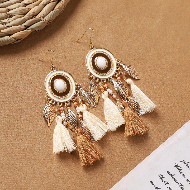 handcrafted feather earrings with long tassels