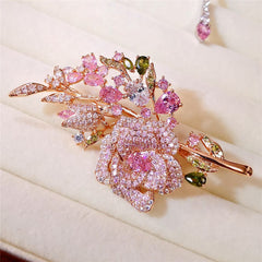 Pink rose bouquet brooch showcased on fabric