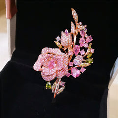 Pink rose bouquet brooch showcased on fabric