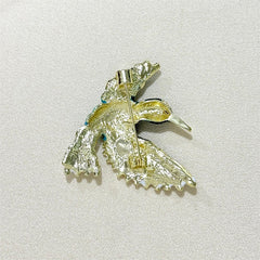 Bird enamel brooch showcasing vibrant colours