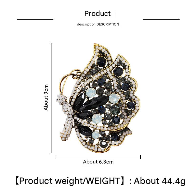 Alloy butterfly brooch on a plain background
