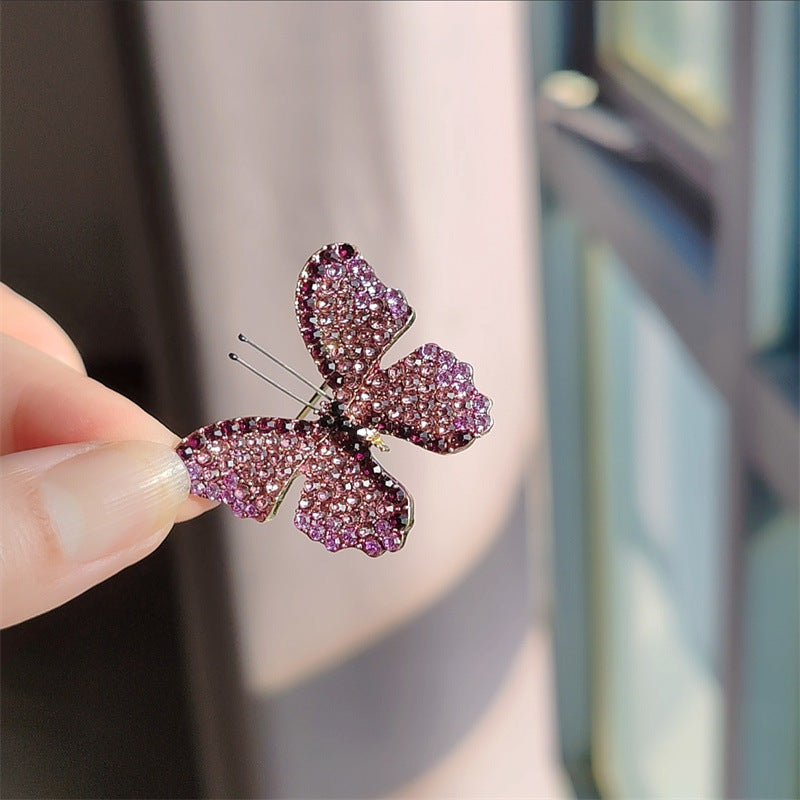 Side view of butterfly brooch showing rhinestone details