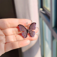 Variations of the butterfly brooch in purple, pink, and blue