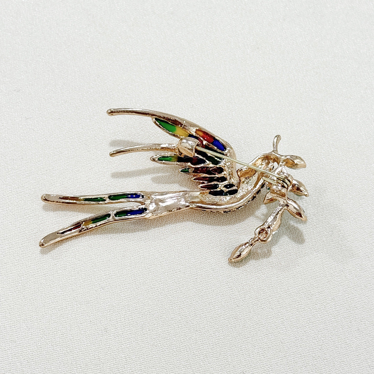 Elegant swallow brooch styled with a dress