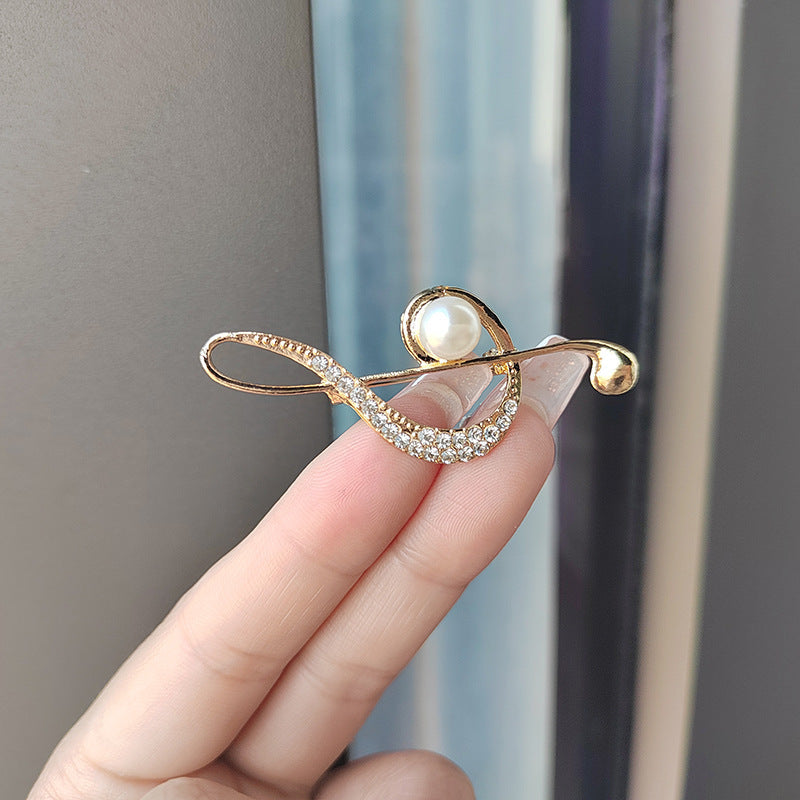 Fashion model wearing music note brooch