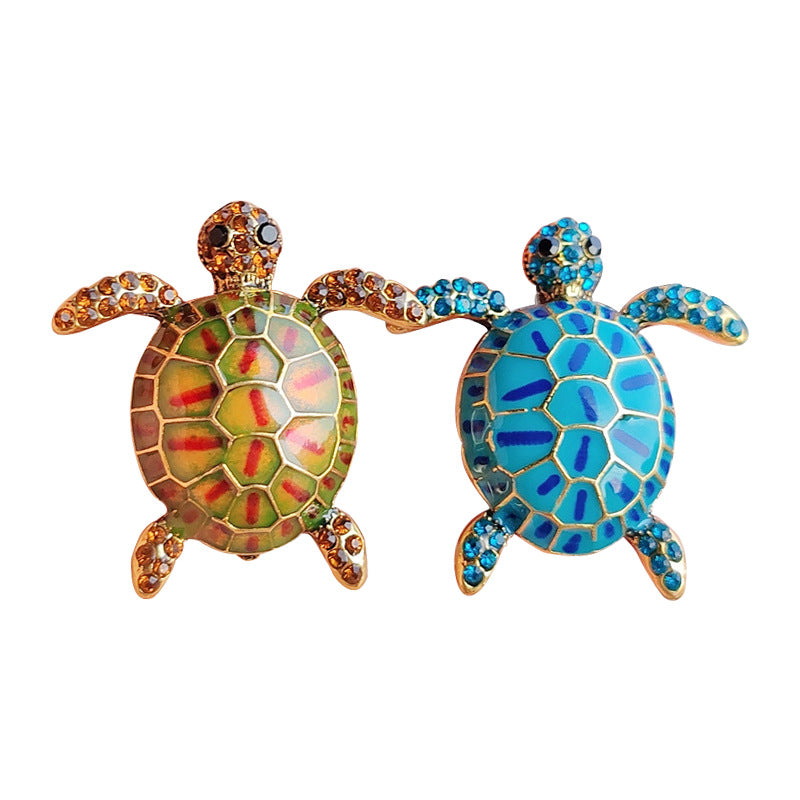 Enamel turtle brooch with vibrant blue design