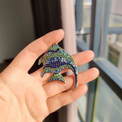 fun tropical fish brooch displayed on a table