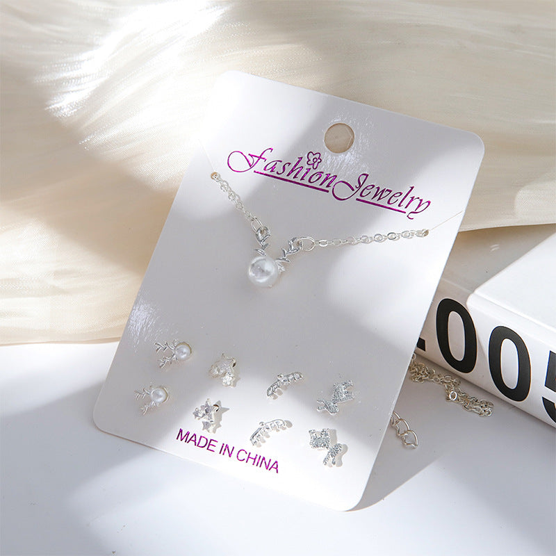 Playful moon and snowman themed earrings close-up