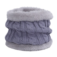 Knit hat and scarf set laid out on a snowy background