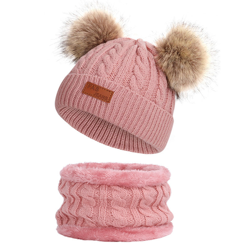 Knit hat and scarf set laid out on a snowy background