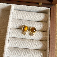 Model wearing vintage tiger eye earrings