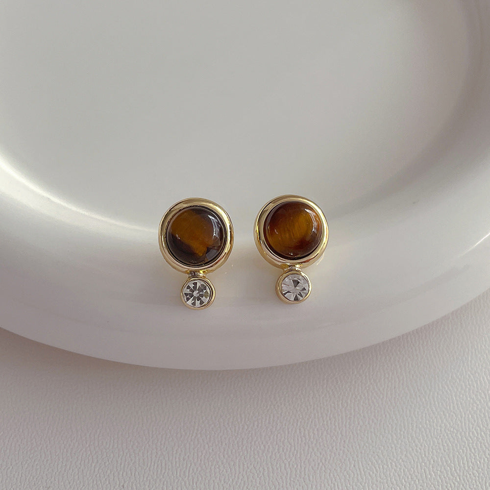 Round vintage tiger eye earrings on a white background