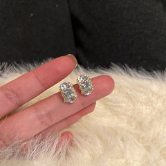 minimalist earrings displayed on a neutral background