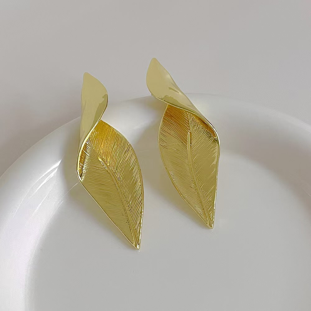 Unique vintage leaf earrings showcased in a box