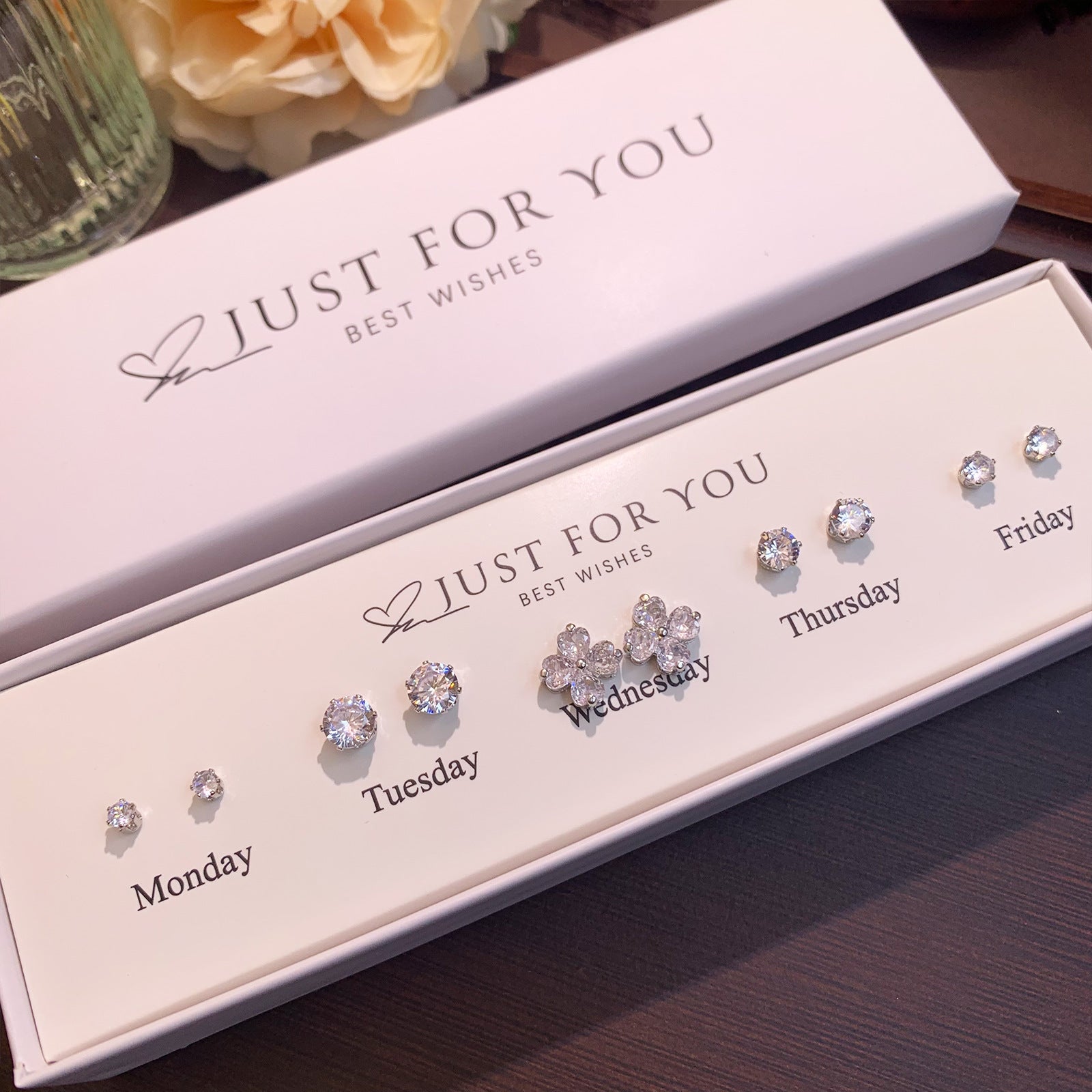 Stylish S925 silver earrings against pastel background