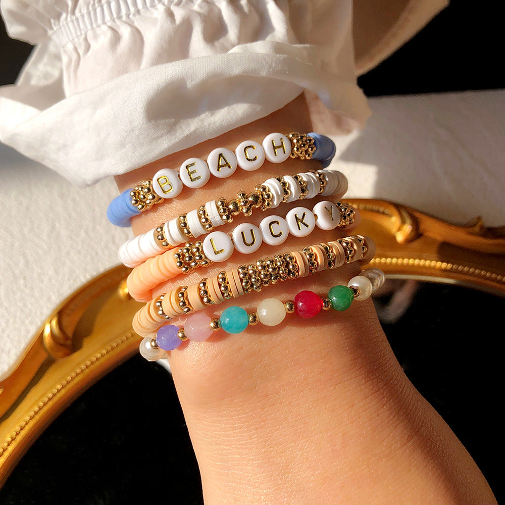 Close-up of colourful geometric charm bracelet