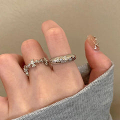 silver zircon cross ring on display with background