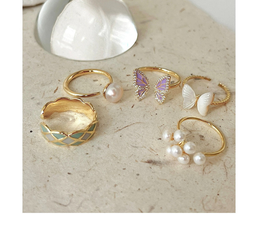 Butterfly ring with pearl accent on display