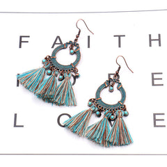 women wearing matching outfit with tassel earrings