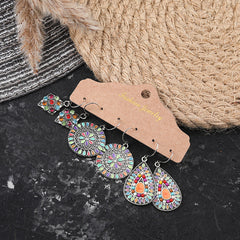 Geometric tassel earrings shown in three pairs