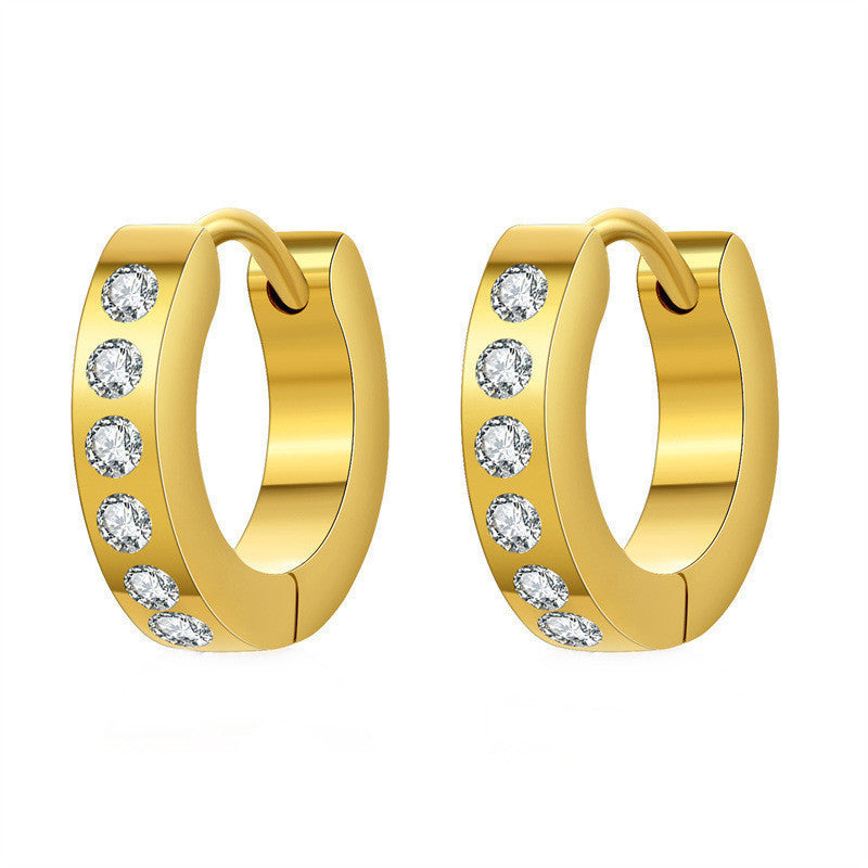 Artistic photo of geometric earrings with zircon stones