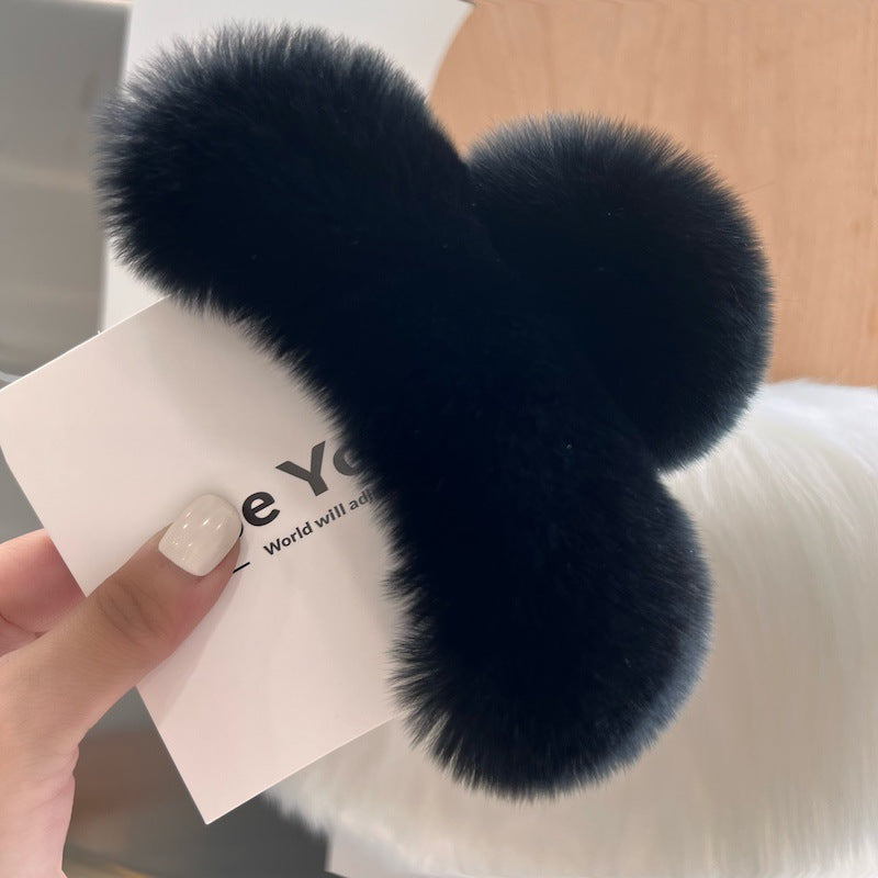Lifestyle image showcasing rabbit fur hair clip in use