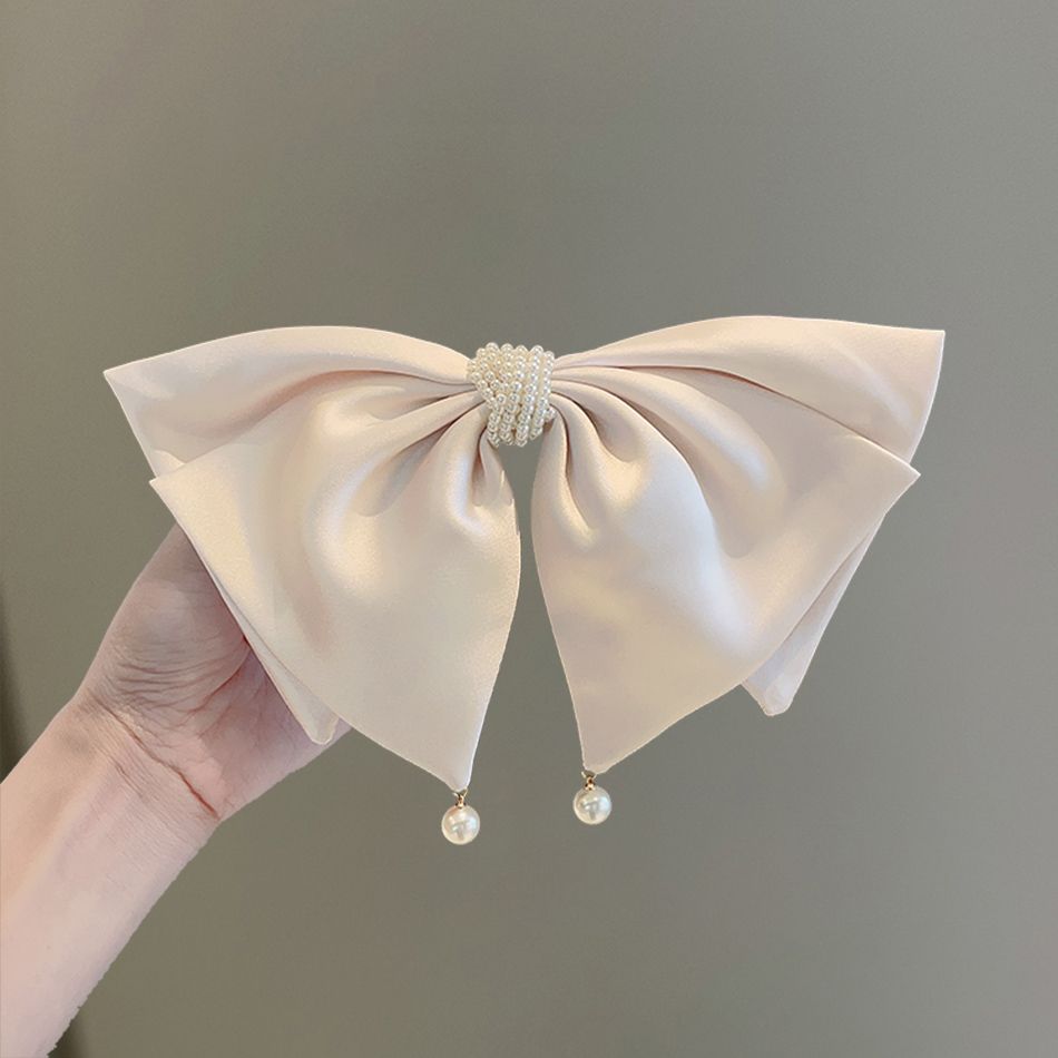 Close-up of satin bow pearl hair clip