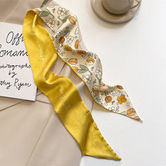 yellow scarf draped over a handbag