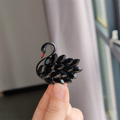 Stylish swan brooch pin displayed on a coat