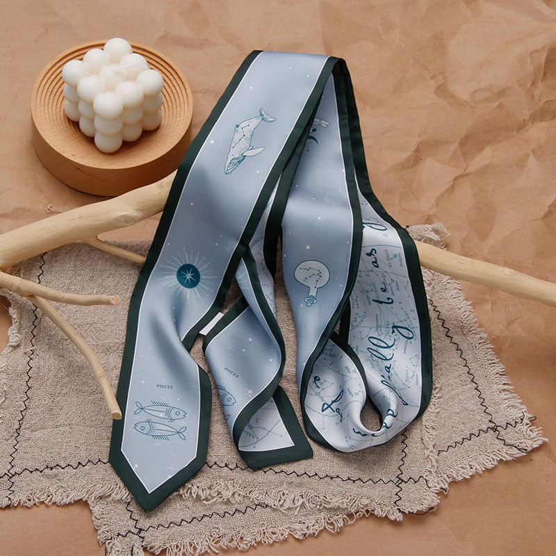 Zodiac silk scarf laid flat to show patterns
